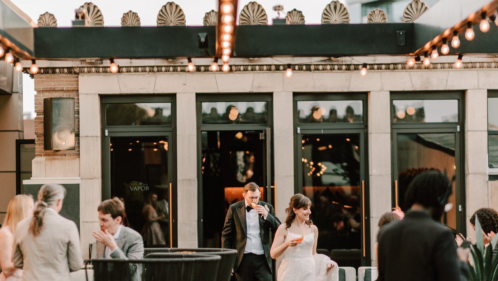 Newlyweds enter cocktail hour at Stratus Rooftop Lounge