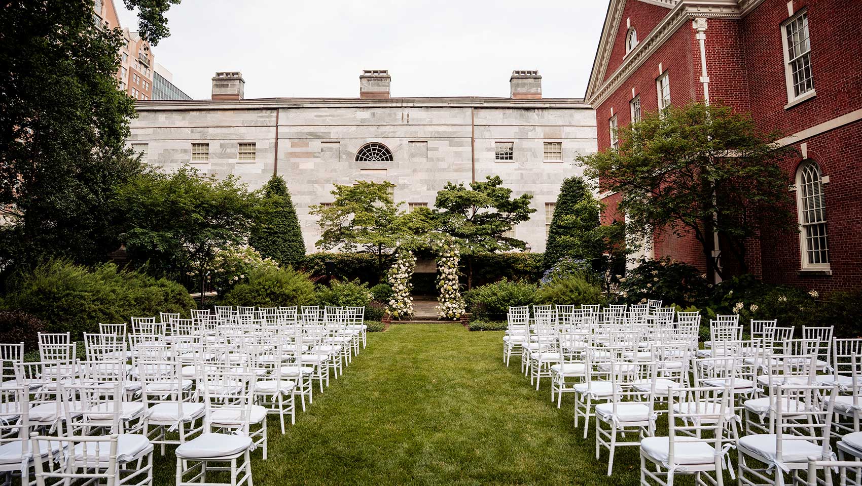 wedding ceremony setup with chairs and flower arch at Thomas Jefferson Garden