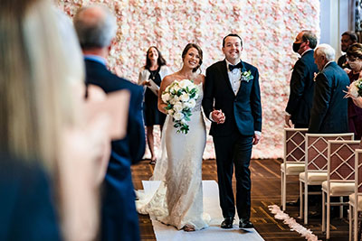 Newlyweds walking down the aisle post-wedding