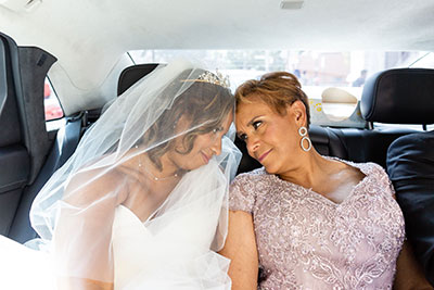 Bride pressing her forehead against maternal figure