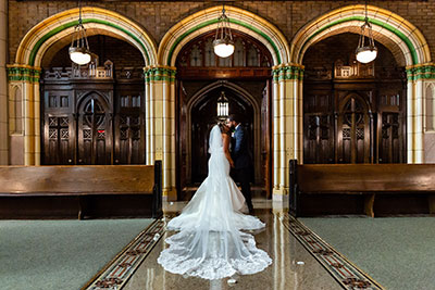 Bride and groom kissing in Philadelphia church