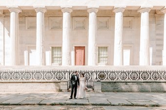 Newlyweds in front of a historical Philly building