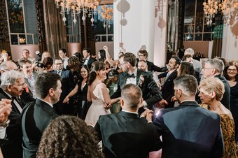 Newlyweds and guests dancing at the reception