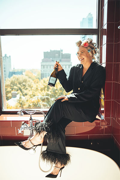 Bride in tub with Champagne