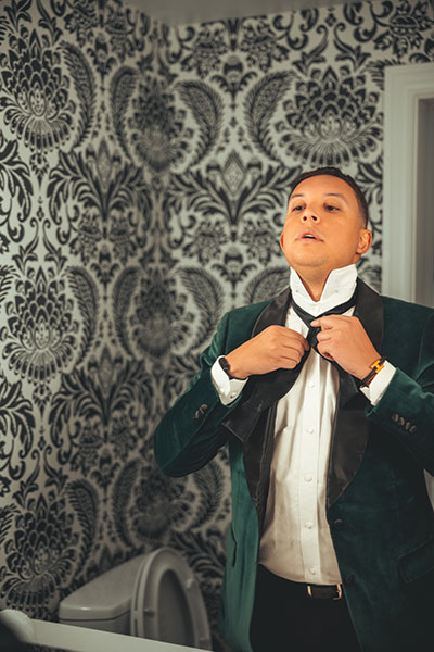 Groom putting on bowtie