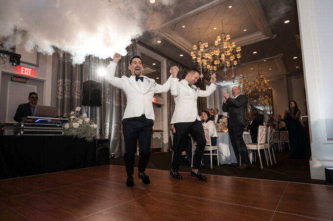 Grooms dancing at their wedding reception