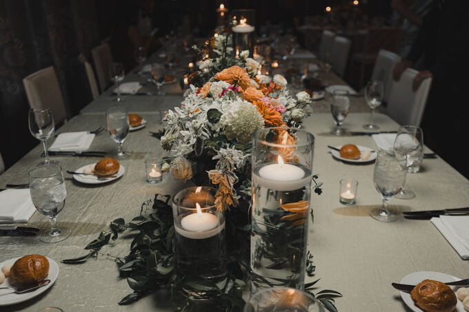 Candlelit wedding reception table with floral centerpiece
