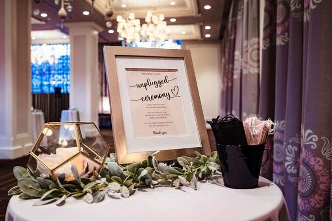 Unplugged ceremony sign on a wedding welcome table
