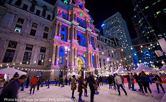 Ice skaters in front of Philadelphia City Hall at night