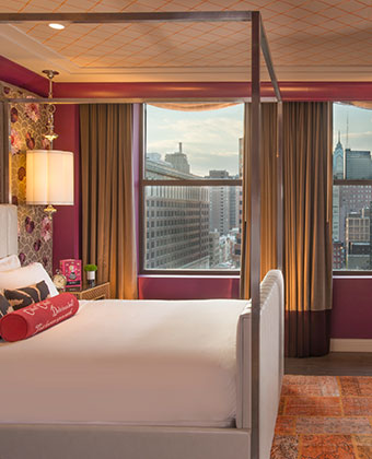 Hotel suite with bed and city views